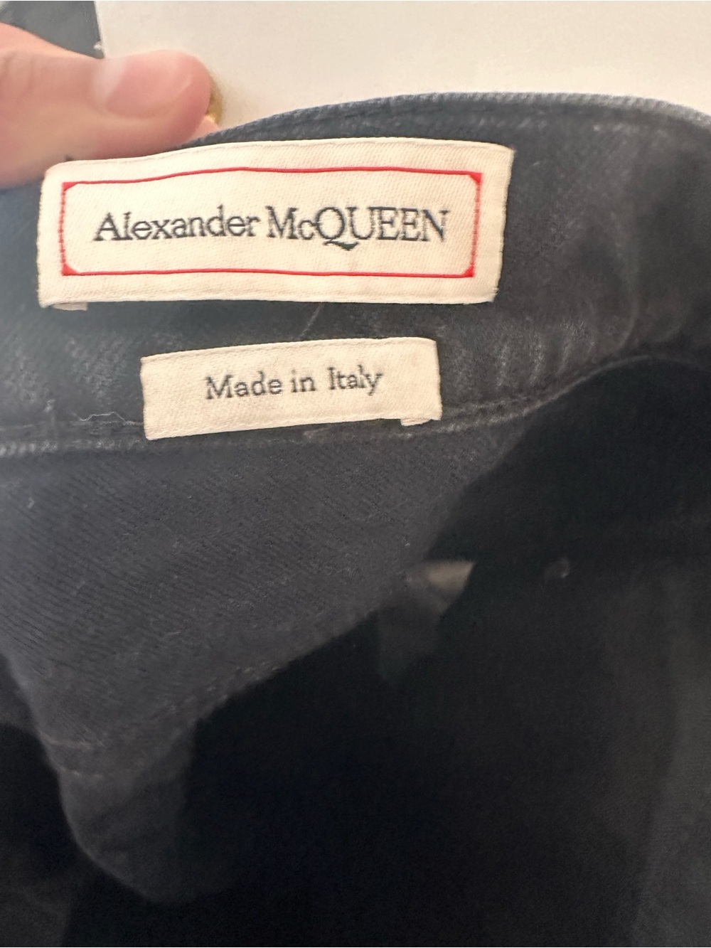 Alexander McQueen Black Garment with White Label and Red Stitching